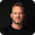 Josh Prior, member of Prosperia Marketing team, professional portrait with serious expression, dark background, showcasing expertise in marketing.